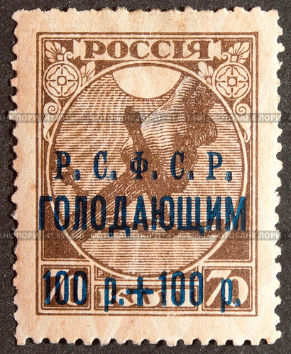 Почтовая марка РСФСР 1922 года с надпечаткой. Голодающим 100 р + 100 р. Благотворительный выпуск для сбора средства в помощь голодающим на Волге. Стоковое фото, фотограф Елена Бобкова / Фотобанк Лори