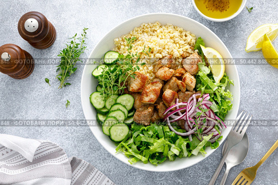 Pork kebab bulgur salad bowl with cucumber, lettuce, thyme and mustard sauce. Стоковое фото, агентство Ingram Publishing / Фотобанк Лори