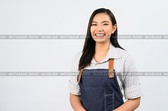 Portrait Asian young woman in waitress uniform smile with happy, Free space to insert product for advertising, isolated on white background. Стоковое фото, агентство Ingram Publishing / Фотобанк Лори