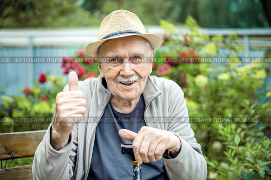 Portrait of a smiling and confident senior 87 years old cute in a hat with a mustache. Happy active old age. Стоковое фото, фотограф Оксана Медведева / Фотобанк Лори
