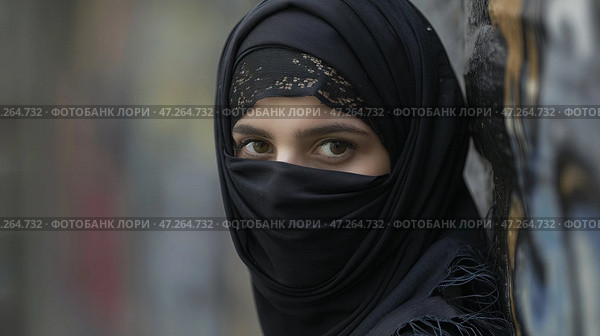 Portrait of a young Muslim woman in black hijab looking at camera. Портрет молодой мусульманки в черном хиджабе, смотрящей в камеру. Стоковое AI-изображение, AI-художник Katsiaryna Repich / Фотобанк Лори