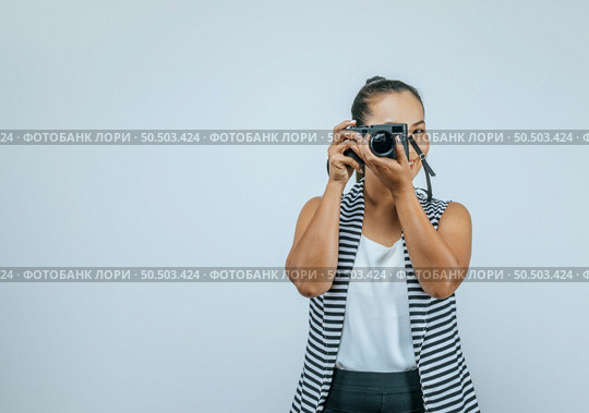 Portrait of Asian woman wearing casual clothes with a big smile on face,  taking pictures with camera. Isolated background in studio with blank space. Стоковое фото, агентство Ingram Publishing / Фотобанк Лори