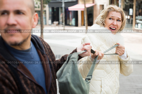 Portrait of frightened woman and robber. Стоковое фото, фотограф Яков Филимонов / Фотобанк Лори
