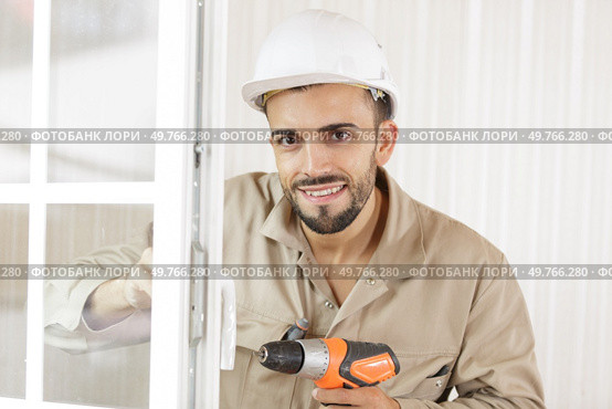 portrait of handsome attractive repairer in protective hard ha. Стоковое фото, агентство Ingram Publishing / Фотобанк Лори