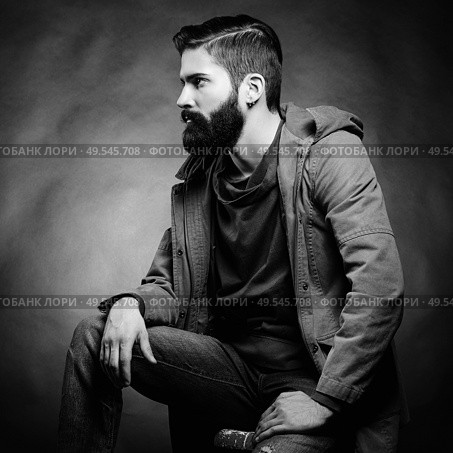 Portrait of handsome man with beard and mustache. Close-up image of serious brutal bearded man on dark background. Black and white photography. Стоковое фото, агентство Ingram Publishing / Фотобанк Лори