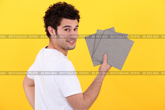portrait of handyman installing tiles. Стоковое фото, агентство Ingram Publishing / Фотобанк Лори