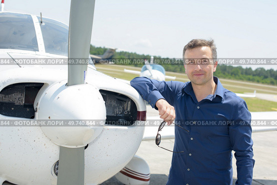 Portrait of man leaning on aircraft. Стоковое фото, агентство Ingram Publishing / Фотобанк Лори