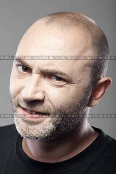 portrait of skeptical looking man isolated on gray background. Стоковое фото, агентство Ingram Publishing / Фотобанк Лори