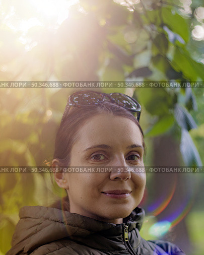 Portrait of smiling brunette woman enjoying wonderful sunny day in nature. Стоковое фото, фотограф Константин Григорьев / Фотобанк Лори
