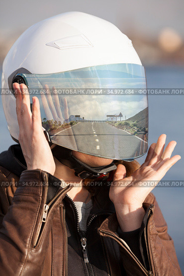 Portrait of unrecognizable European female motorcyclist with road reflection in her mirrored tinted visor of a helmet, collage. Стоковое фото, фотограф Кекяляйнен Андрей / Фотобанк Лори
