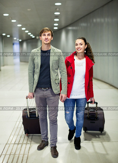 Portrait of young couple with wheeled trollers. Стоковое фото, фотограф Яков Филимонов / Фотобанк Лори