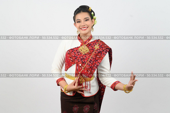 Portrait Young beautiful woman in northeastern dress, she raising hand in Thai dance with charming smile on white background, copy space . Стоковое фото, агентство Ingram Publishing / Фотобанк Лори