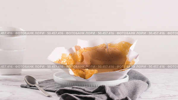 Portuguese sponge cake wrapped in the typical paper used on the baking, on marble background. Стоковое фото, агентство Ingram Publishing / Фотобанк Лори