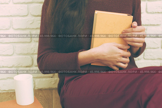 Pretty relaxed young woman reading a book. Стоковое фото, фотограф Сергей Толмачёв / Фотобанк Лори