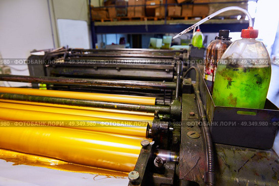 Printer ink machine rotary printing. Printer ink machine rotary printing factory golden printer rollers. Стоковое фото, агентство Ingram Publishing / Фотобанк Лори