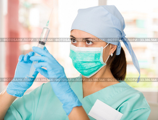 Professional nurse young woman making injection in hospital. Стоковое фото, фотограф Яков Филимонов / Фотобанк Лори