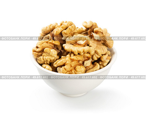 Purified walnuts in a white ceramic bowl on a white  background. . Стоковое фото, агентство Ingram Publishing / Фотобанк Лори