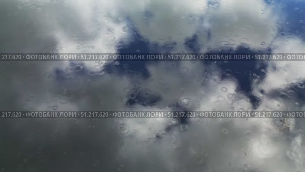 Rain and sky with clouds reflection in water. Стоковое видео, видеограф Михаил Коханчиков / Фотобанк Лори