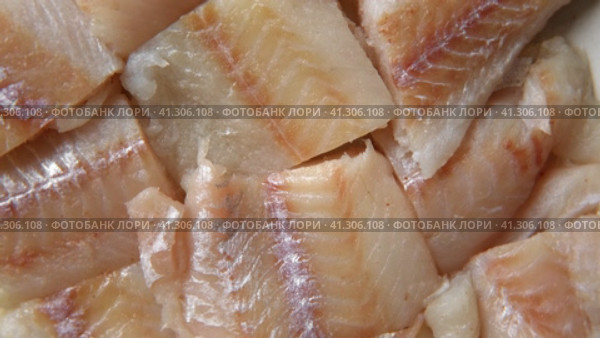 Raw fish fillet is spinning. Top view. Slices of fresh whitefish. Full frame. Sashimi rotation. Close up. Marine market. Video for sale. Cod, pollock loin steaks. Pangasius, tilapia pieces background. Стоковое видео, видеограф Марина Демидюк / Фотобанк Лори