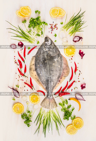 Raw flounder fish with fresh seasoning,lemon and spices on  withe rustic wooden background, top view. Стоковое фото, агентство Ingram Publishing / Фотобанк Лори