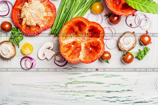Red paprika with cutting  top , ready for stuffing and tasty cooking ingredients on white rustic wooden background, top view, border.  Vegetarian food and Healthy eating concept. Стоковое фото, агентство Ingram Publishing / Фотобанк Лори