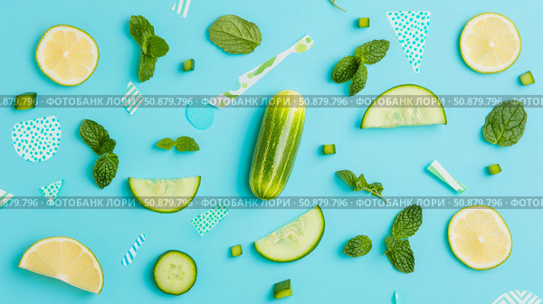 Refreshing Summer: Cool cucumber, lemon, and mint flatlay arrangement on a bright aqua surface for wellness and healthy living. Стоковое AI-изображение, AI-художник Данила Большаков / Фотобанк Лори