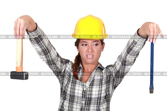 Revolted woman looking at her tools. Стоковое фото, агентство Ingram Publishing / Фотобанк Лори