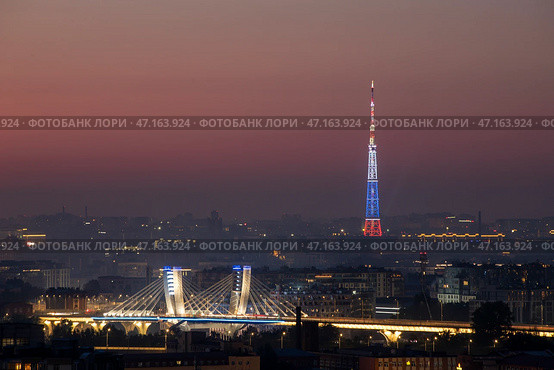 Россия. Санкт-Петербург. Крыши города. Вид на мост Бетанкура и телебашню с подсветкой в виде российского флага (2020 год). Редакционное фото, фотограф Литвяк Игорь / Фотобанк Лори