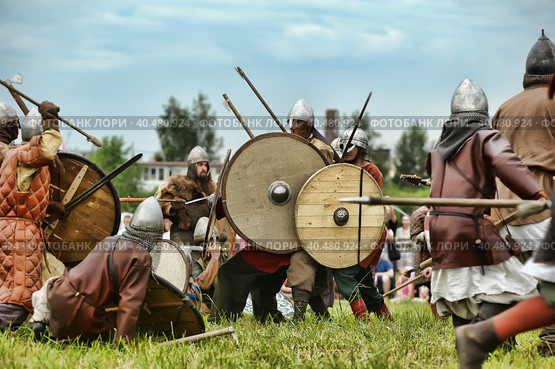 Russia, Staraya Ladoga 23,06,2012 Reenactors with shields and spears during the battle, the festival of historical reconstruction "Pages of History" Стоковое фото, фотограф Анна Кривицкая / Фотобанк Лори