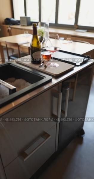 Russia, St.Petersburg, 24 April 2025: bottle of champagne is cooled in a niche with ice in the restaurant, local lighting, wine cabinet, decanters for sparkling wine. Редакционное видео, видеограф Vladimir Drozdin / Фотобанк Лори