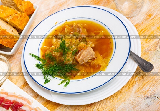 Russian dish Shchi - sour cabbage soup served in bowl. Стоковое фото, фотограф Яков Филимонов / Фотобанк Лори