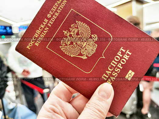 Russian passport held while preparing for international travel at customs before crossing the border. Стоковое фото, фотограф Кривошеина Елена Леонидовна / Фотобанк Лори