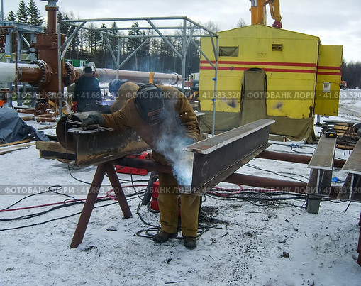 Safety at work. Welding and grinding of iron constructions. Industrial weekdays welders and fitters. Стоковое фото, фотограф Леонид Еремейчук / Фотобанк Лори