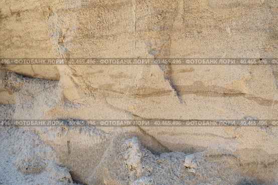 Sandstone is a fragmentary sedimentary rock, a homogeneous or layered aggregate of fragmentary grains and grains of sand bound by any mineral substance, cement. Quarry natural yellow sand wall. Стоковое фото, фотограф Юлия Петровская / Фотобанк Лори