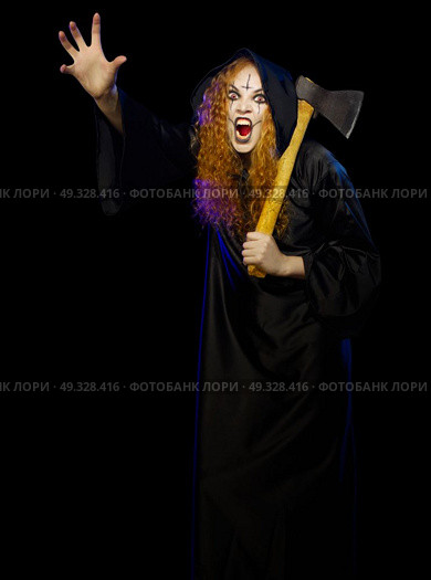 Scary young witch isolated on black. Стоковое фото, агентство Ingram Publishing / Фотобанк Лори