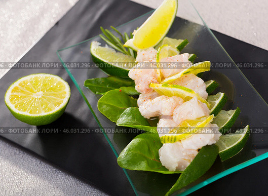 Seafood ceviche from hake on a glass plate with lime and greens. Стоковое фото, фотограф Яков Филимонов / Фотобанк Лори