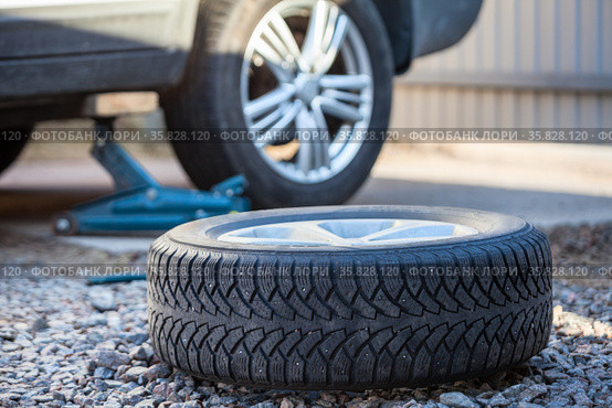 Seasonal winter tyre change. Snow tire lying on ground, is ready to install, spring. Стоковое фото, фотограф Кекяляйнен Андрей / Фотобанк Лори