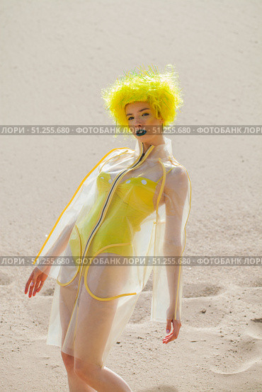 Sexy beautiful woman in a bright yellow wig and transparent raincoat. Стоковое фото, фотограф Андрей Аркуша / Фотобанк Лори