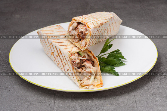 shawarma or doner kebab with chicken on a white plate. Стоковое фото, фотограф Дмитрий Ульянов / Фотобанк Лори