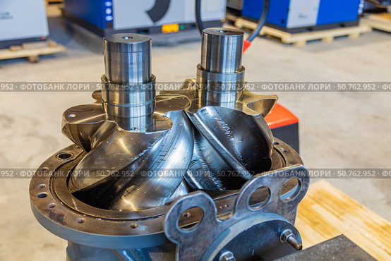 Shiny new screw compressor rotors showing engineering precision. Стоковое фото, фотограф Юрий Поздников / Фотобанк Лори