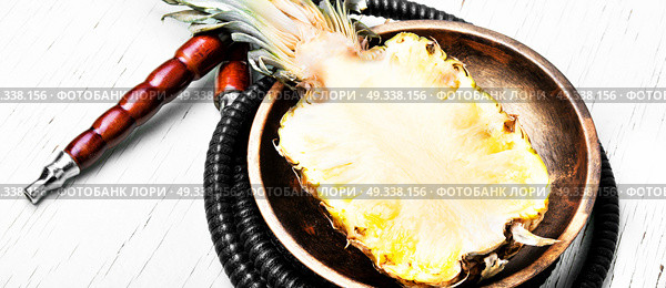 Shisha hookah with pineapple. Stylish hookah with the aroma pineapple for relax.Pineapple shisha.Hooka lounge. Стоковое фото, агентство Ingram Publishing / Фотобанк Лори