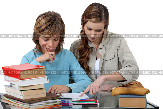 Sister helping her sibling with an assignment. Стоковое фото, агентство Ingram Publishing / Фотобанк Лори