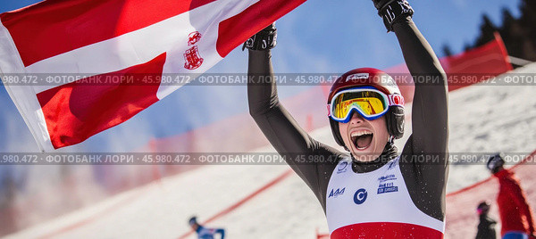 Skier celebrating victory with latvian flag at competition. Стоковое AI-изображение, AI-художник Юрий Поздников / Фотобанк Лори