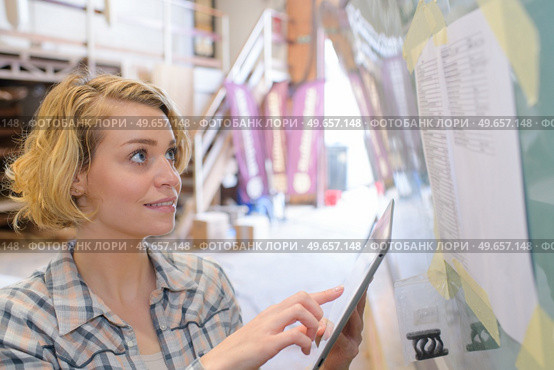 smiling blonde female engineer checking planing. Стоковое фото, агентство Ingram Publishing / Фотобанк Лори