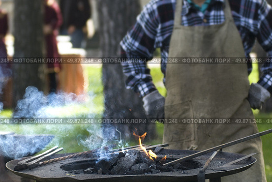 Smith against fireplace with instruments. Стоковое фото, агентство Ingram Publishing / Фотобанк Лори