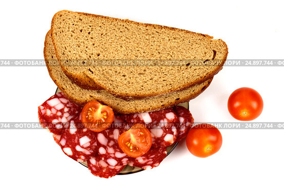 Smoked sausage, cherry tomatoes and bread on a white background. Стоковое фото, фотограф Artem Sobov / Фотобанк Лори