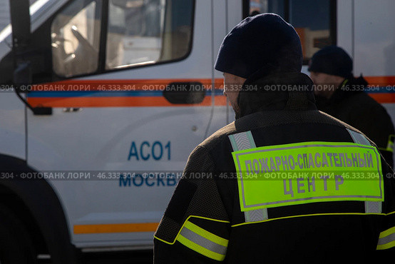 Сотрудник МЧС России стоит у автомобиля специальной службы в городе Москве, Россия. Редакционное фото, фотограф Николай Винокуров / Фотобанк Лори