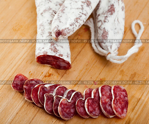 Spanish sausage fuet on a wooden table, closeup. Стоковое фото, фотограф Яков Филимонов / Фотобанк Лори