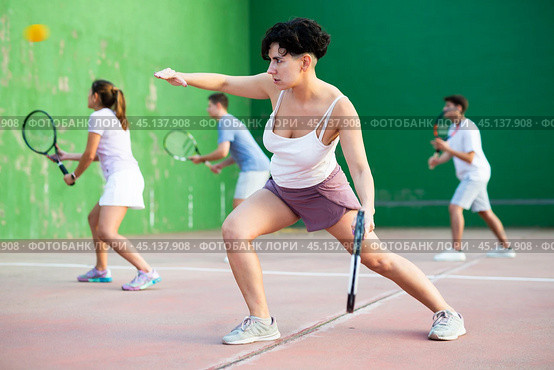 Sportive woman in shorts and t-shirt playing frontenis on court. Стоковое фото, фотограф Яков Филимонов / Фотобанк Лори