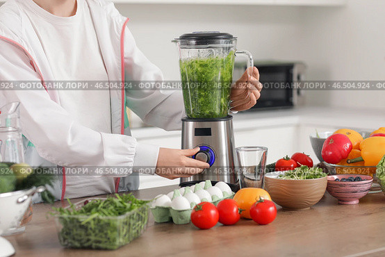 Спортивная молодая женщина с блендером, готовящая смузи на кухне, крупный план. Стоковое фото, фотограф Pixel_shot / Фотобанк Лори